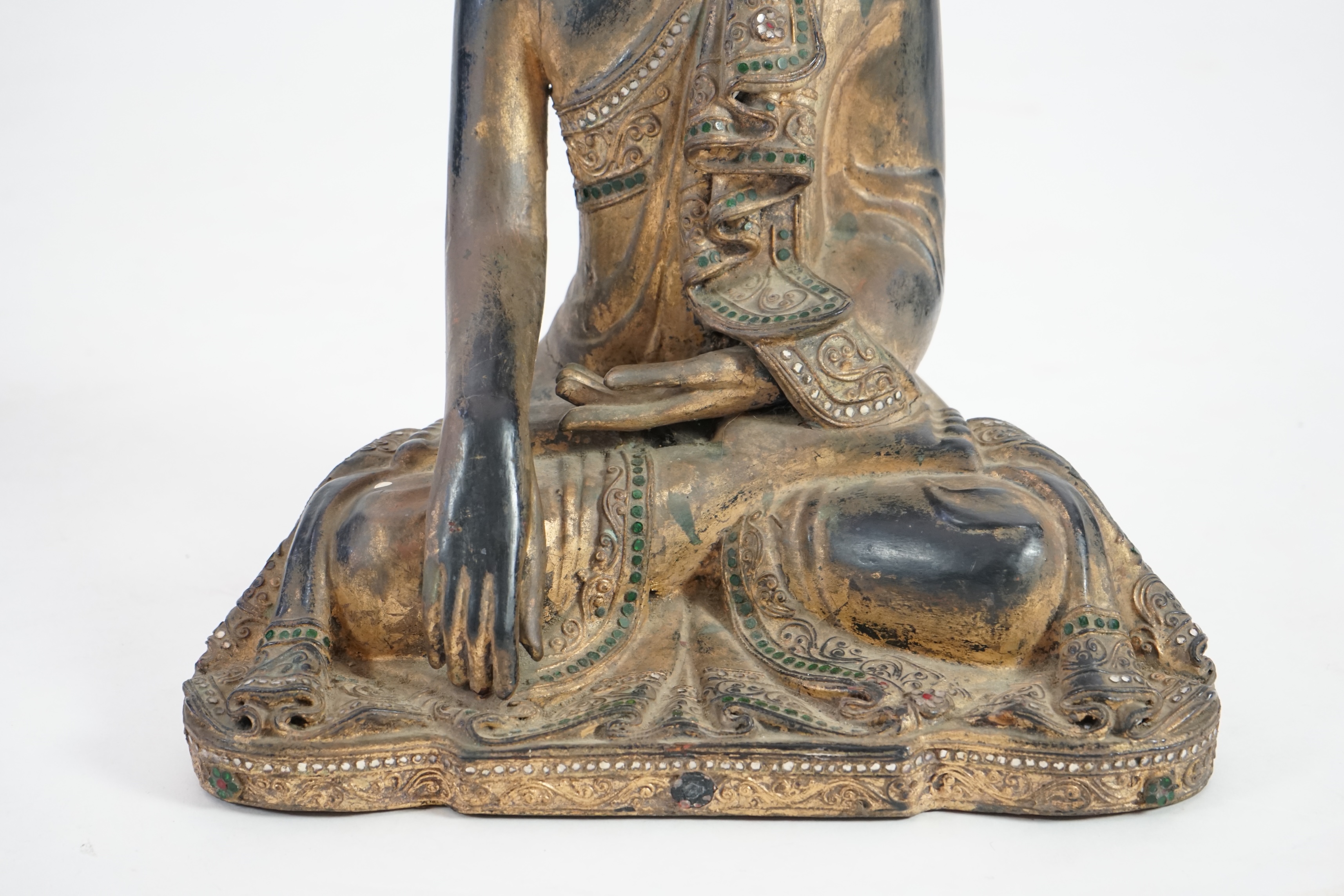 An Asian gem set lacquered and carved wood Buddha